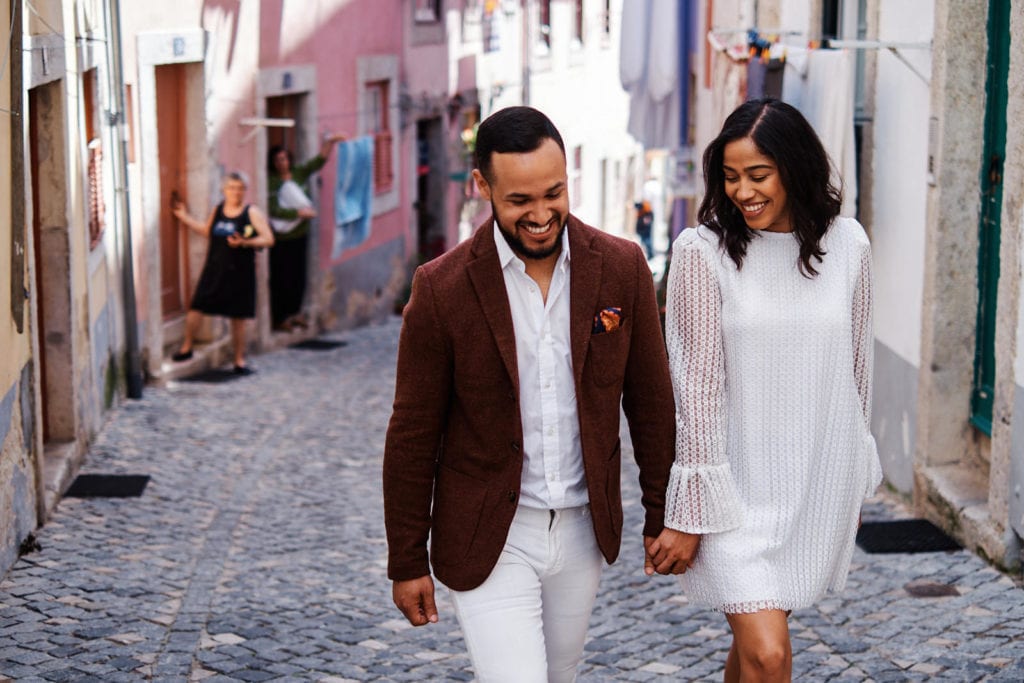 a couple walks hand in hand near Lisbon's Castle during their engagement shoot with Lisbon Photographers Your Story in Photos