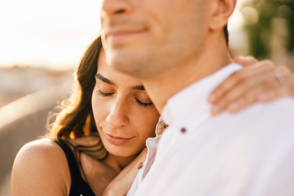 close up of couple in a romantic pose enjoying the moment with closed eyes, late afternoon in LIsbon