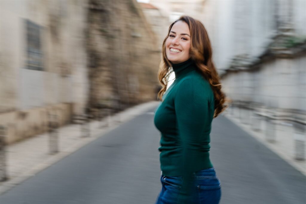 Panning shot of solo traveler crossing the street in Lisbon