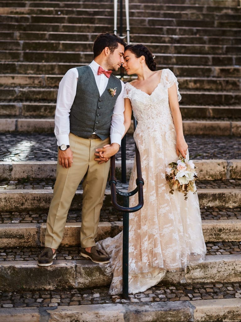 A newlywed couple in a romantic pose during their elopement in Lisbon