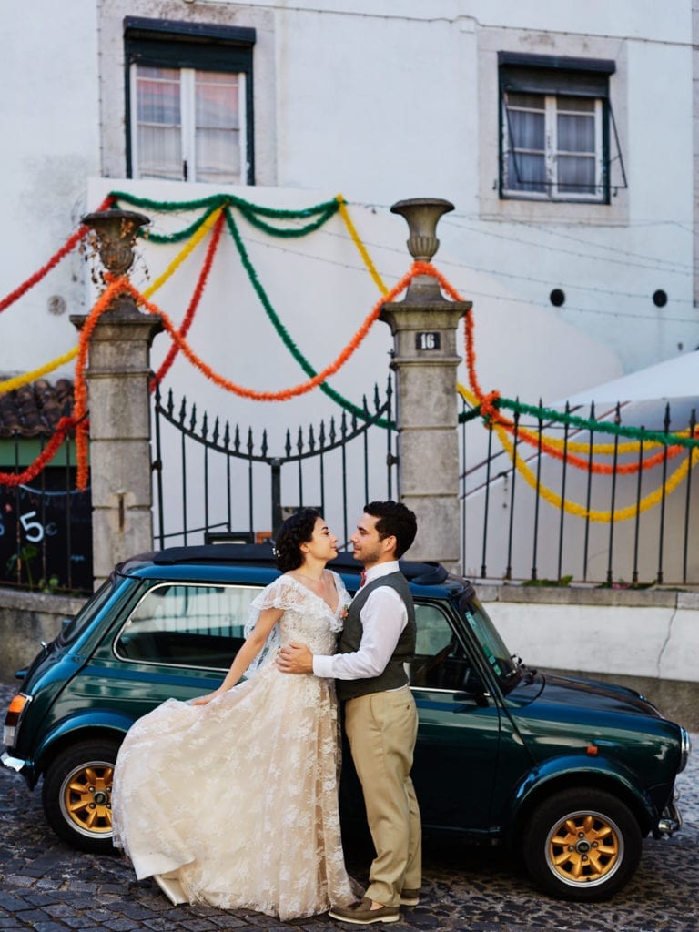 a bride and a groom hug in the street in Lisbon, Portugal