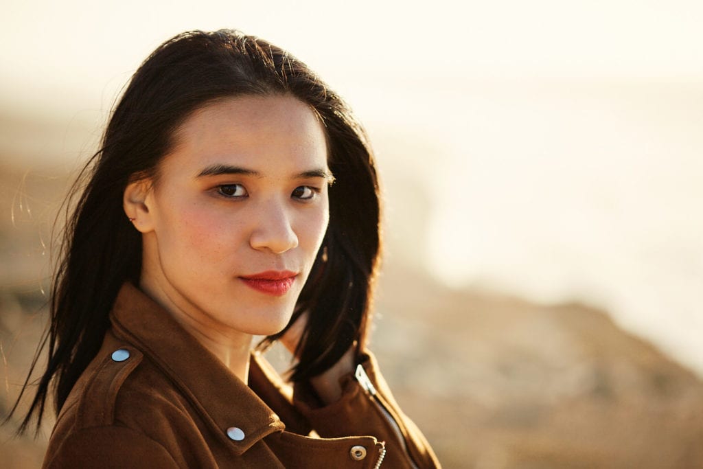 a portrait taken as part of a branding photoshoot on the Guincho coast, in Portugal, during the golden hour of sunset